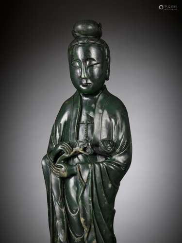 A LARGE AND MASSIVE SPINACH-GREEN KHOTAN JADE FIGURE OF GUAN...