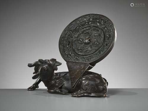 A BRONZE 'XINIU' MIRROR STAND AND 'LION AND GRAPEVINE' MIRRO...