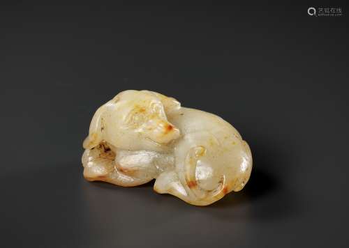 A PALE CELADON AND RUSSET JADE FIGURE OF A DOG, 17TH-18TH CE...