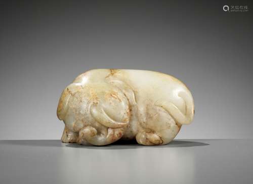 A CELADON AND RUSSET JADE FIGURE OF AN ELEPHANT, MING DYNAST...