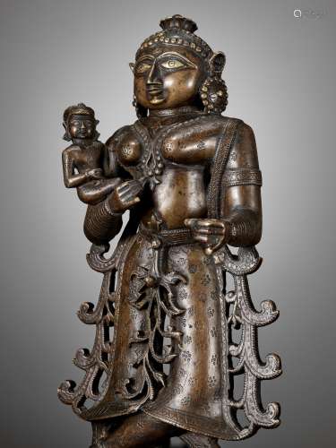 A LARGE BRONZE FIGURE OF YASHODA WITH KRISHNA AS A CHILD