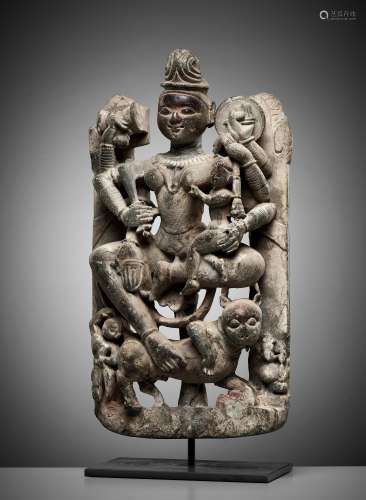A GRAY SCHIST RELIEF OF THE JAIN GODDESS AMBIKA WITH HER COM...