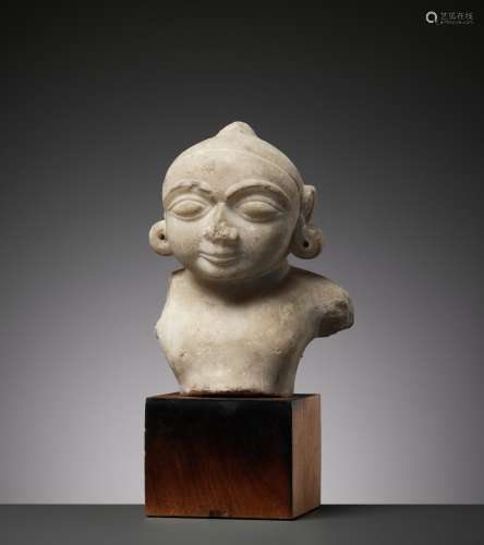 A JAIN WHITE MARBLE BUST OF THE CHILD KRISHNA, 14TH-15TH CEN...