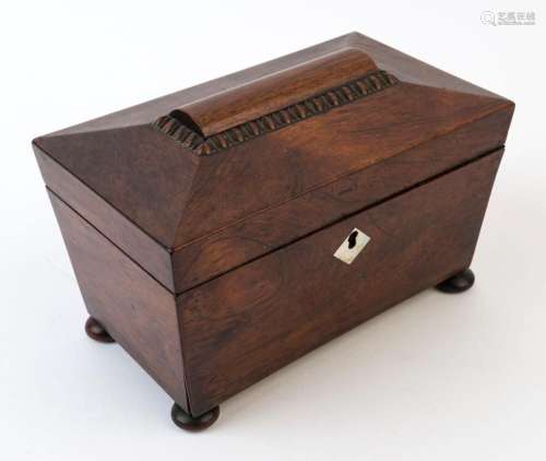 An antique English rosewood tea caddy with twin compartments...