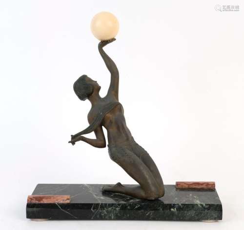 An Art Deco spelter statue of a kneeling female with ball,  ...