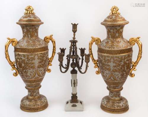 A pair of porcelain lidded mantel urns with gilt decoration,...