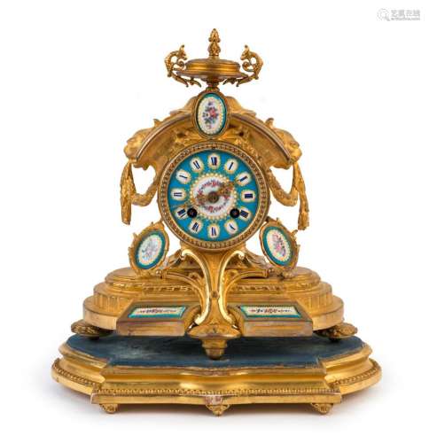 A French antique mantel clock in a gilt metal case with time...