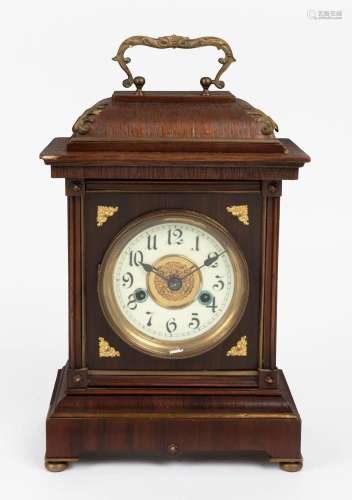 An antique German mantel clock in walnut case with gilt meta...