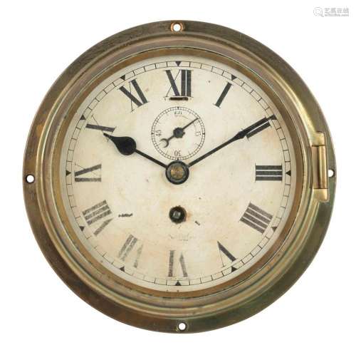 An antique English circular brass cased porthole clock, time...