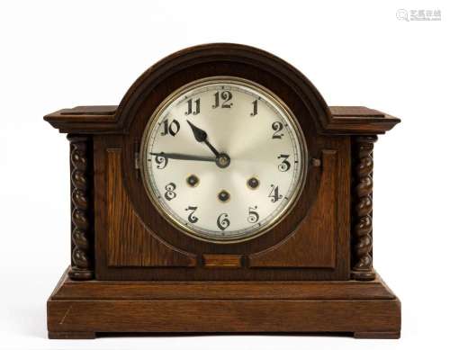 A German Tudor style oak cased mantel clock with triple trai...