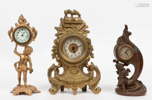 Three antique gilt metal cased table clocks, German and Amer...