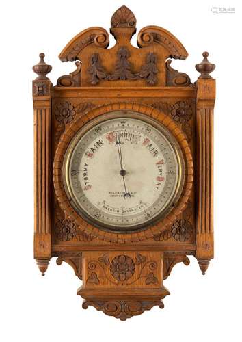 An antique wall barometer mounted in a finely carved oak fra...