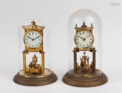 Two German 400 day anniversary clocks in glass domes, 20th c...