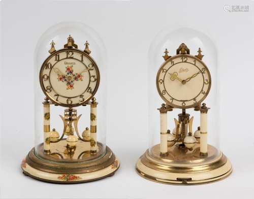 Two German 400 day anniversary clocks in glass and perspex d...