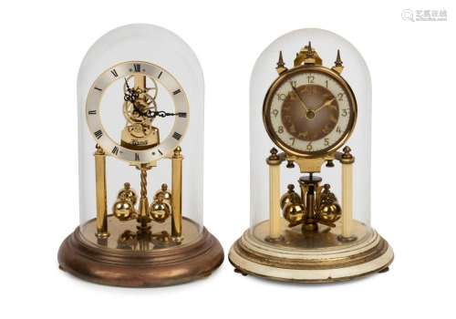 Two German 400 day anniversary clocks in glass domes, one wi...