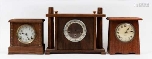 Three vintage mantel clocks in square finished timber cases,...