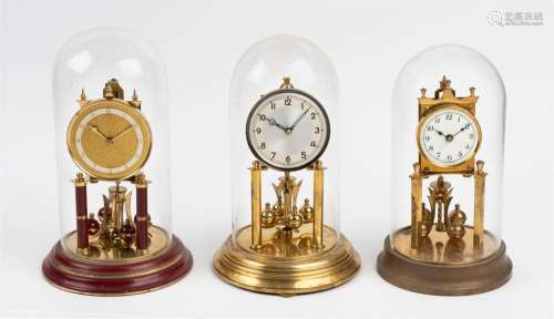 Three German 400 day anniversary clocks in glass domes, 20th...