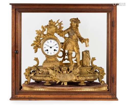 An antique French mantel clock in figural gilt metal case wi...