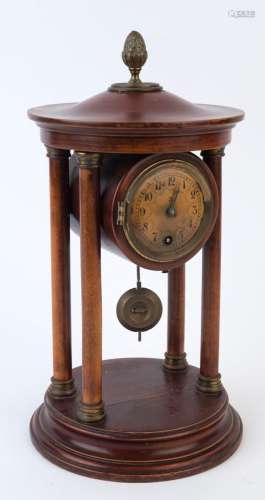 An antique mantel clock, timepiece only in cylindrical timbe...