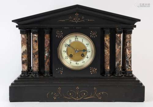 An antique French mantel clock in black slate case with roug...