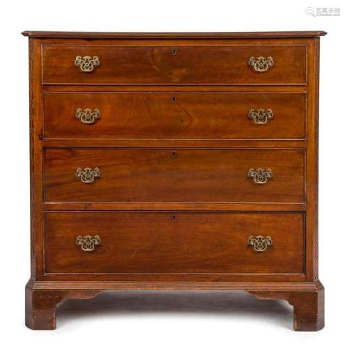 An antique four drawer mahogany chest with Chippendale carve...