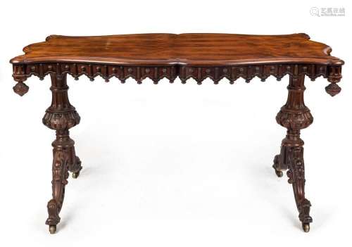 An antique English rosewood centre table with finely carved ...