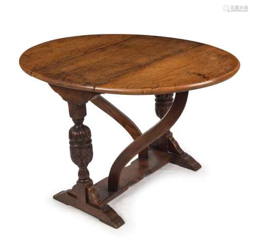 An antique English oak drop-side occasional table in the Tud...