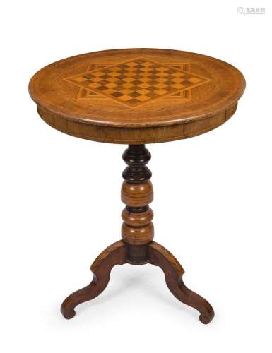 An antique walnut circular games table with chess and gaming...