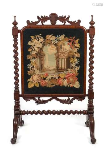 An antique English mahogany fire screen with barley twist de...