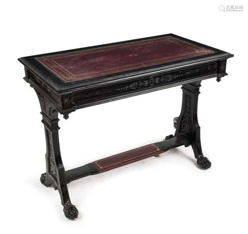 An antique English ebonised sofa table with carved claw feet...