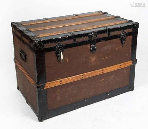 An antique timber and metal bound travel trunk, 19th/20th ce...