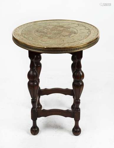 A circular brass top occasional table with Tudor style oak b...