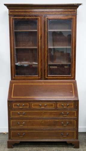 An English Sheridan style bureau bookcase, flame mahogany wi...