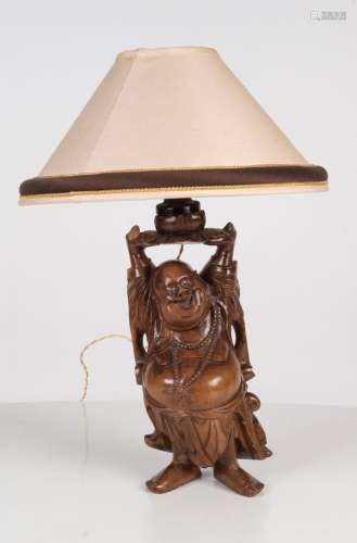 A Chinese figural carved wooden table lamp and shade, 20th c...