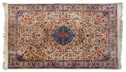 A Persian hand-knotted wool rug with fine floral motif on be...