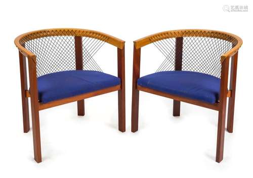 A pair of Danish designer tub chairs with blue upholstered s...