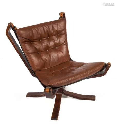 A Scandinavian lounge chair with chocolate leather upholster...