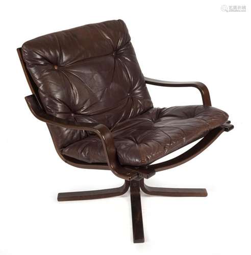 A Scandinavian armchair with chocolate leather upholstery, 7...