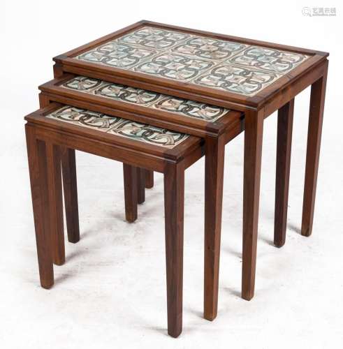 A nest of three Danish rosewood tile top coffee tables, circ...