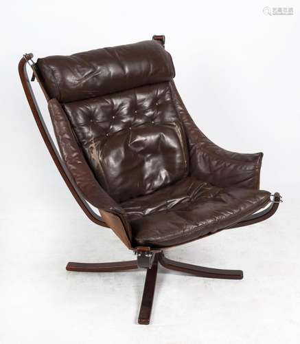 A vintage Danish brown leather flared armchair with brown st...