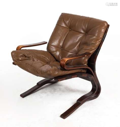 A Scandinavian brown leather upholstered cantilever armchair...