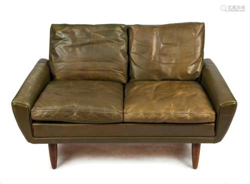 A vintage Danish two seat settee with green leather and turn...