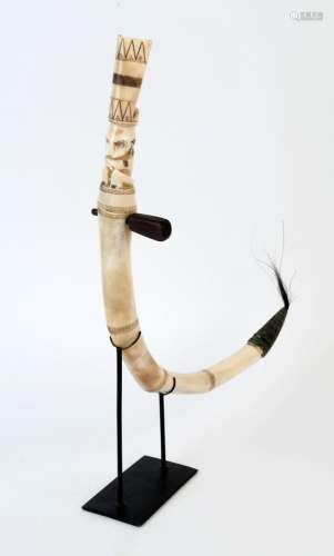 A medicine horn with figural top, carved bone, horn, hair an...