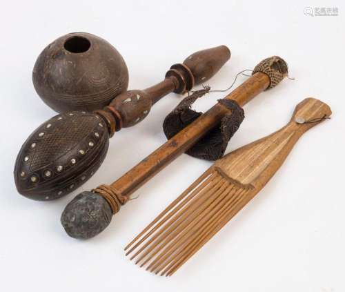 Four tribal artefacts including a carved coconut shell, bamb...