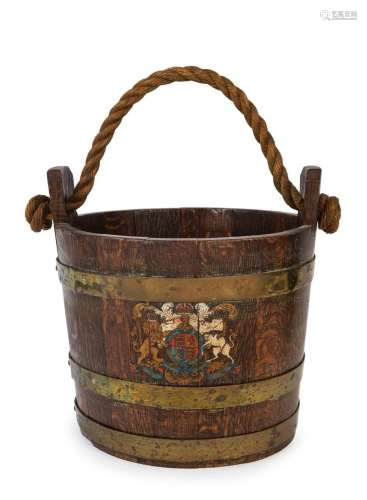 An antique oak and brass bucket of coopered construction wit...