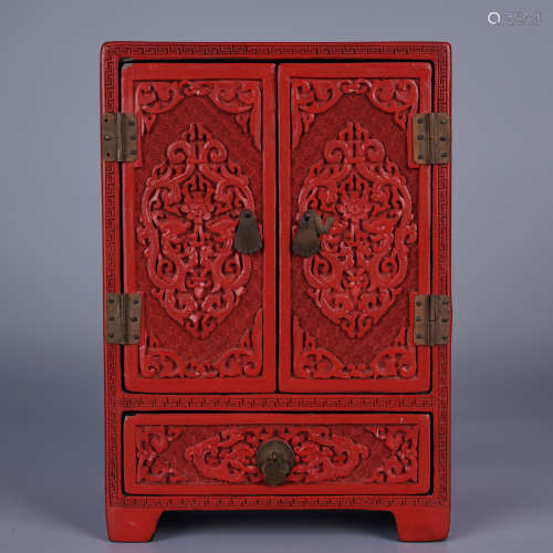 A CARVED CINNABAR LACQUER CABINET