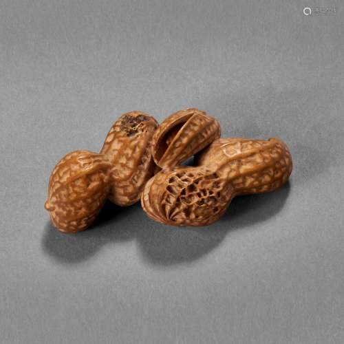 A CARVED WOOD SCULPTURE ( NETSUKE ) OF PEANUTS 20TH CENTURY,...