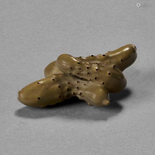 A CARVED WOOD SCULPTURE ( NETSUKE ) OF PICKLED CUCUMBERS AND...