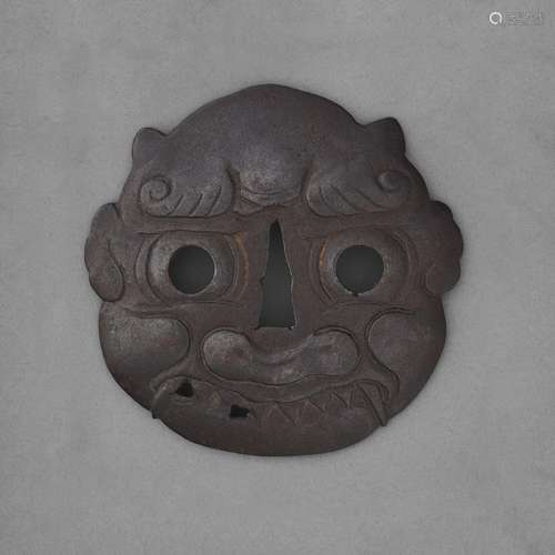 A LARGE IRON TSUBA IN THE FORM OF AN ONI MASKEDO PERIOD (18T...