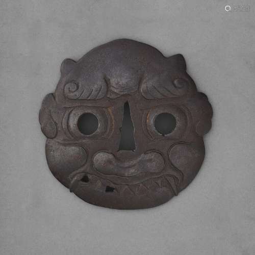 A LARGE IRON TSUBA IN THE FORM OF AN ONI MASKEDO PERIOD (18T...